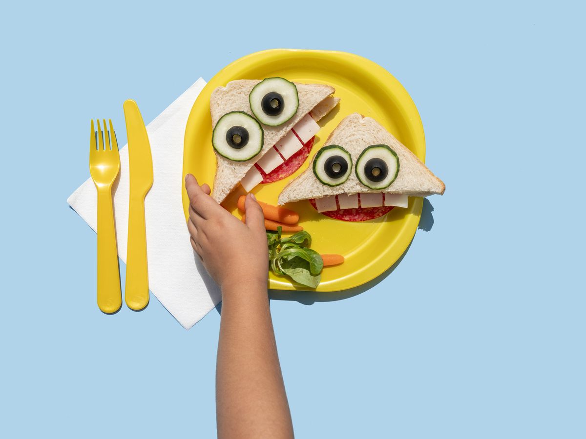 https://hips.hearstapps.com/hmg-prod/images/hand-of-baby-girl-picking-up-funny-looking-sandwich-royalty-free-image-1654027736.jpg?crop=0.88931xw:1xh;center,top&resize=1200:*