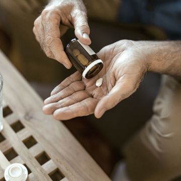 hand pours pills from bottle