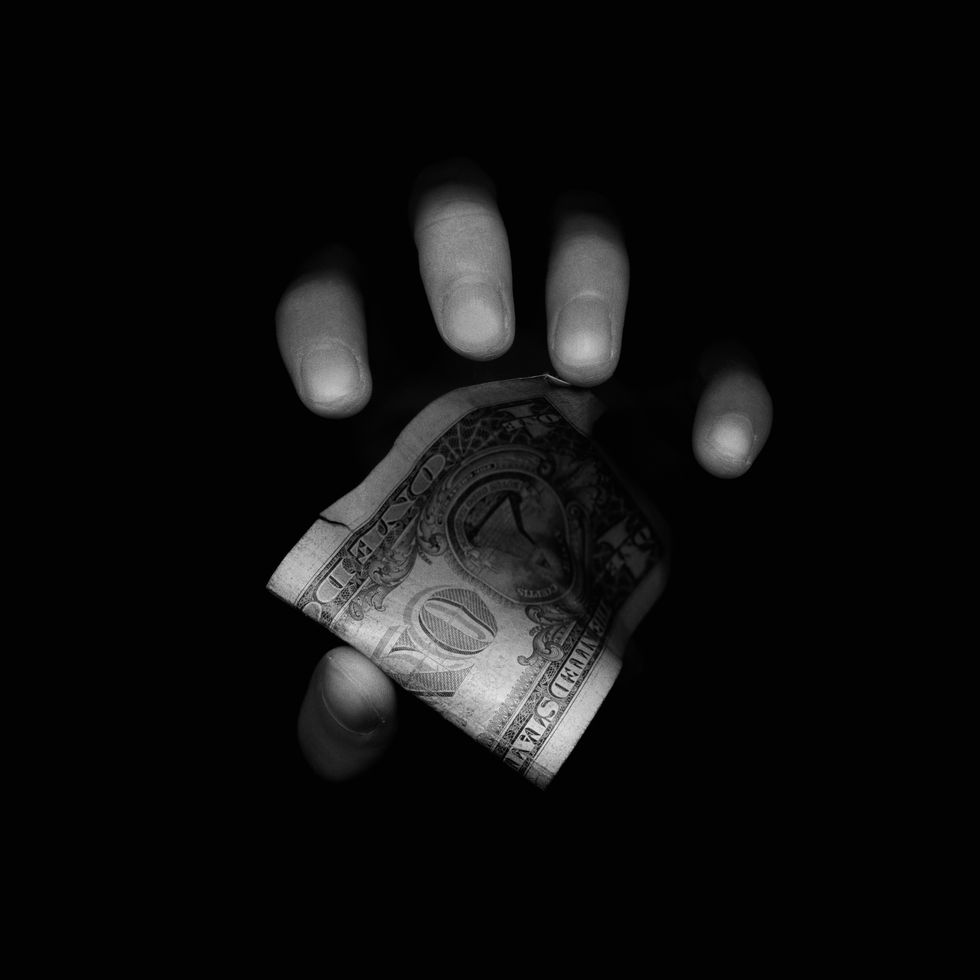 hand reaching for us one dollar bill