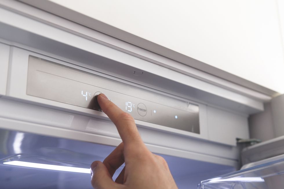 hand sets temperature of refrigerator