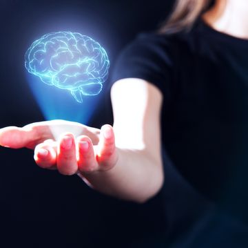 hand showing a brain hologram