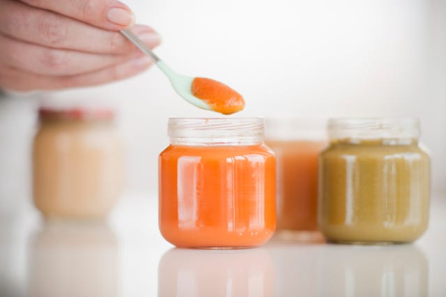 hand spooning baby food