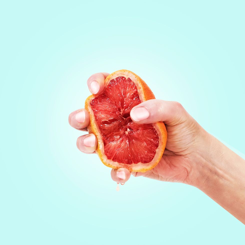 hand squeezing grapefruit
