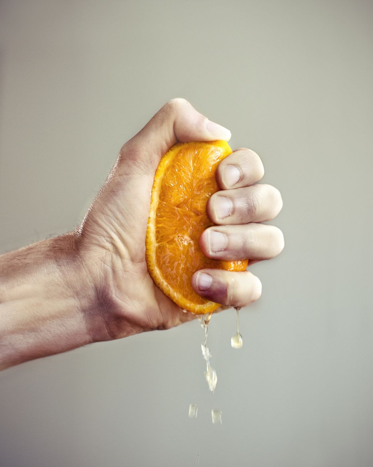 Hand squeezing orange