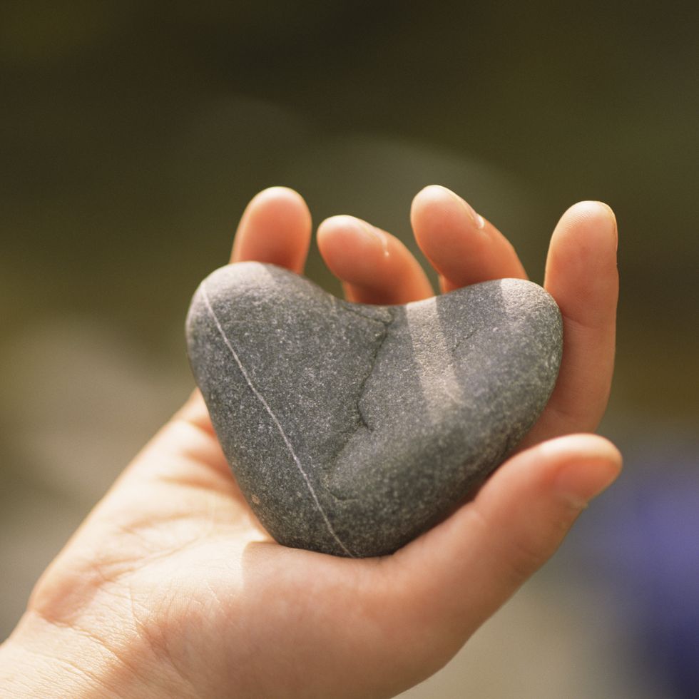 hand with heart shaped stone