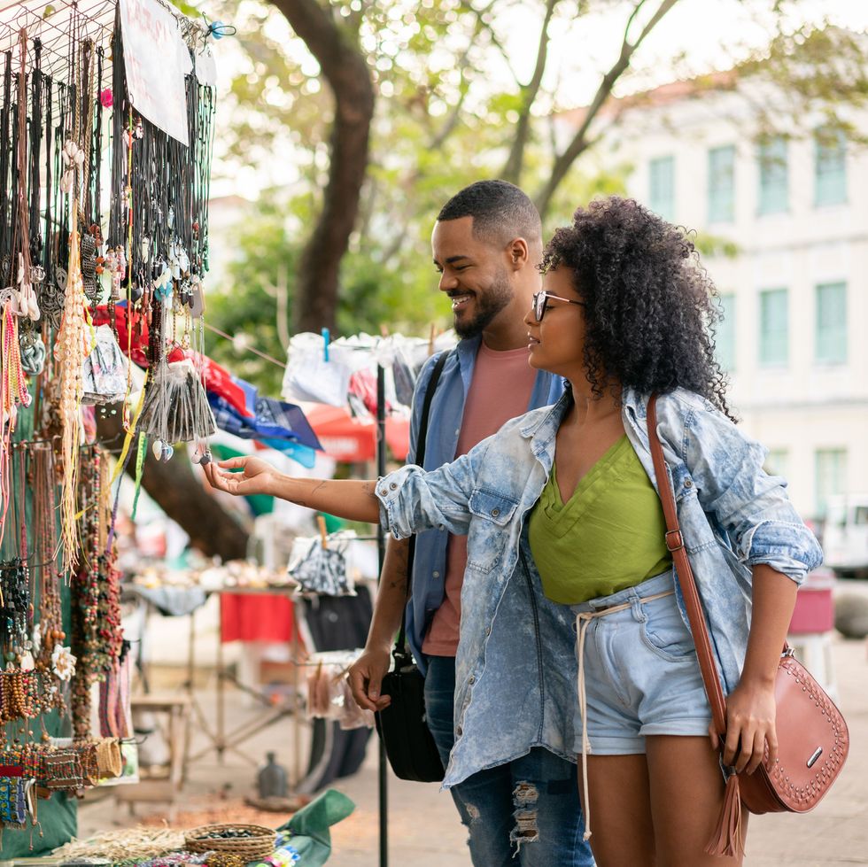 black couple looking at jewelry during a street fair on a summer date