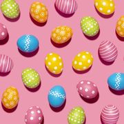 handmade decorated easter eggs on pink background