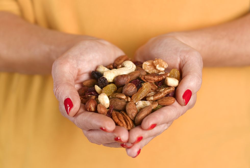 HANDS HOLDING A SELECTION OF NUTS