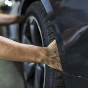 hands of mechanic changing a wheel of a modern car