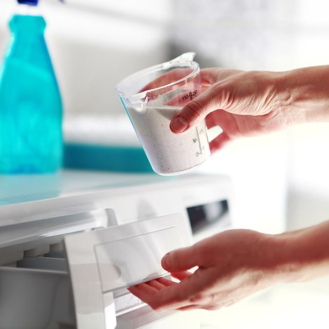 powder detergent being added to a washing machine drawer