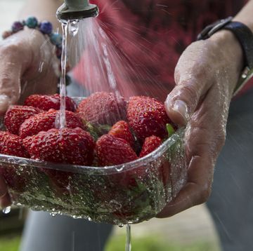 persona lavando unas fresas