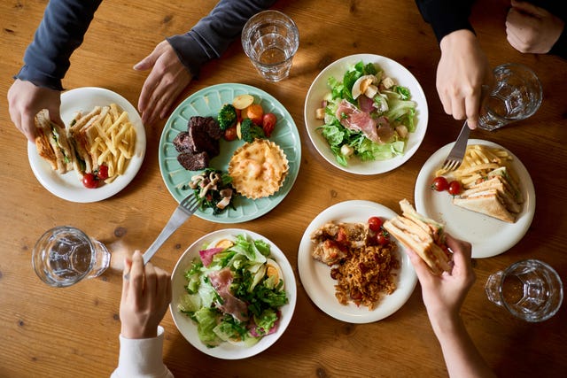 hands of women eating at a girls' association