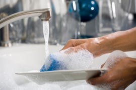 hands washing a plate
