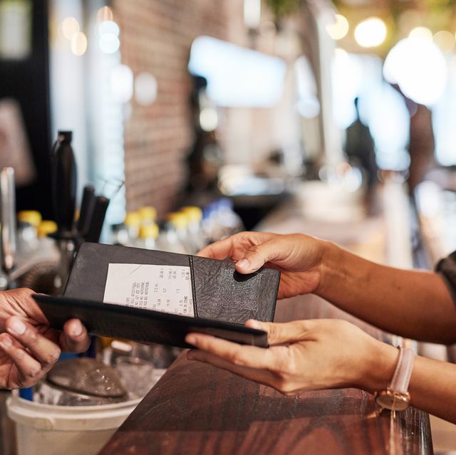 hands with bill, food service and people in restaurant, customer with receipt and payment with cashier or waiter. fine dining, dinner and check at cafe, catering and hospitality with finance
