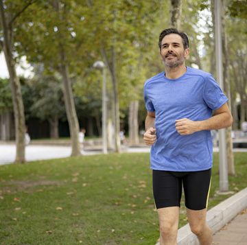 handsome fit middle aged man of hispanic ethnicity exercising outdoors