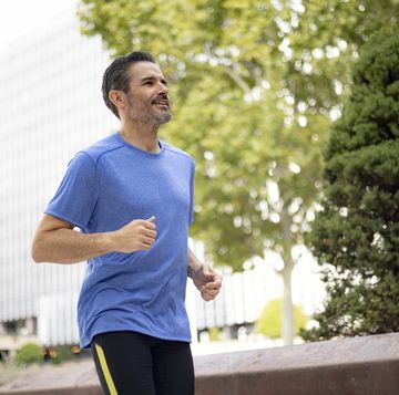 handsome fit middle aged man of hispanic ethnicity exercising outdoors