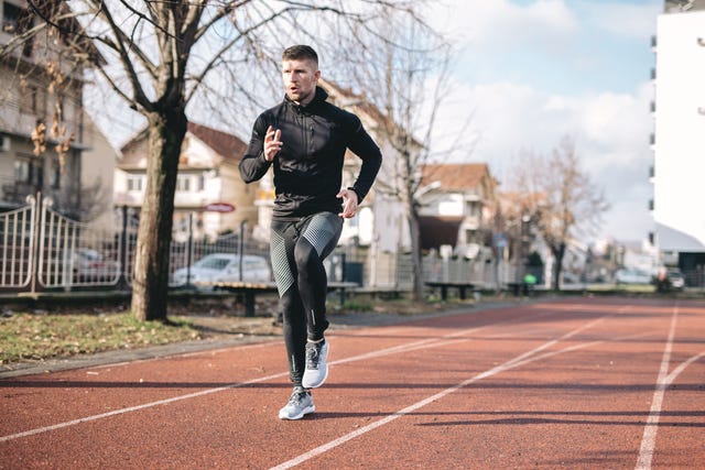 handsome man jogging on a track