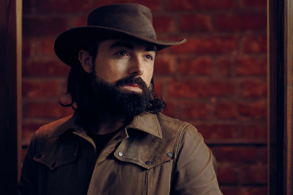 handsome man wearing cowboy hat in western style portrait