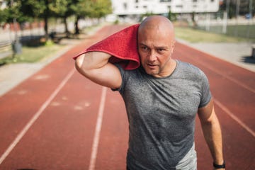 handsome mature man after training on a running track