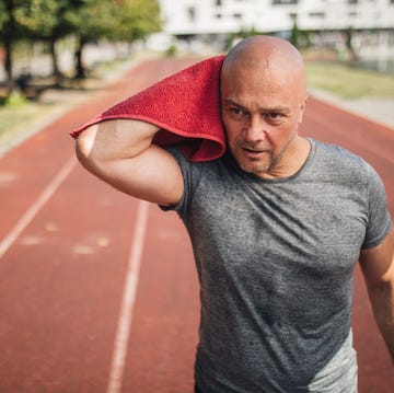 Handsome mature man after training on a running track handsome mature man after training on a running track