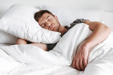 handsome young man sleeping in bed