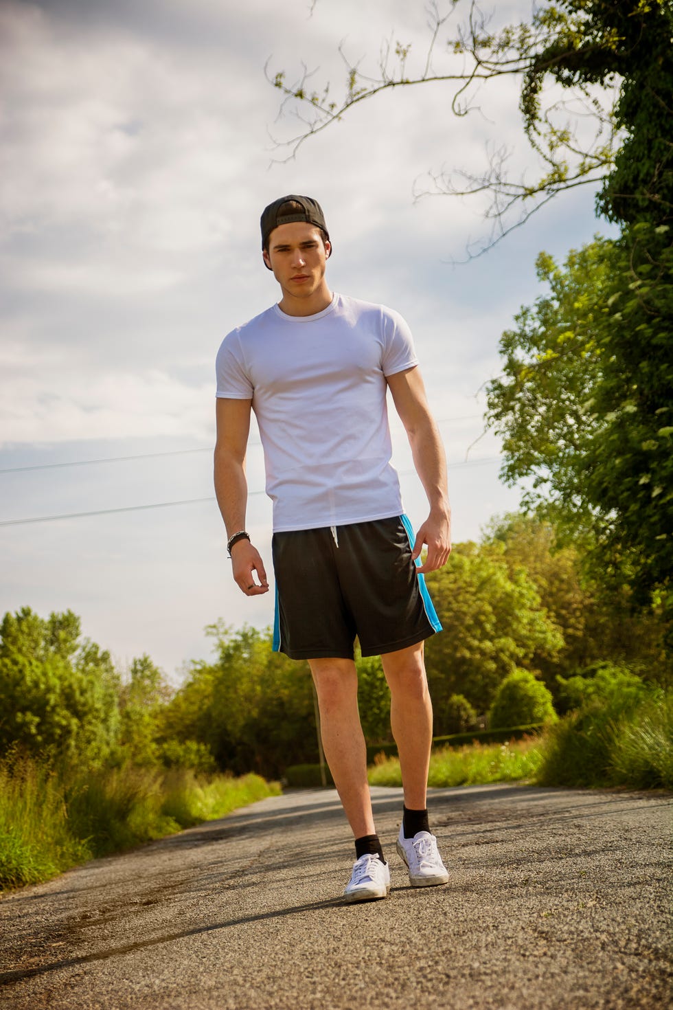 handsome young man walking and trekking on road
