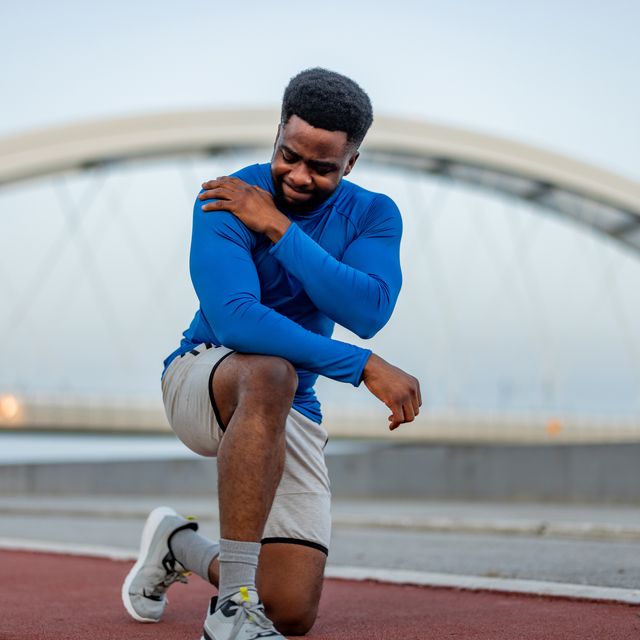 handsome young sportsman have physical injury of shoulder during a practice