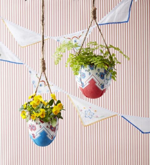 hanging planters wrapped in scarves with flowers small backyard ideas