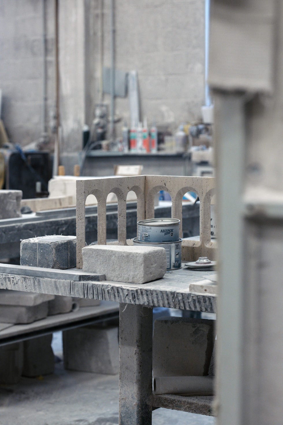 workroom with several stone sculptures