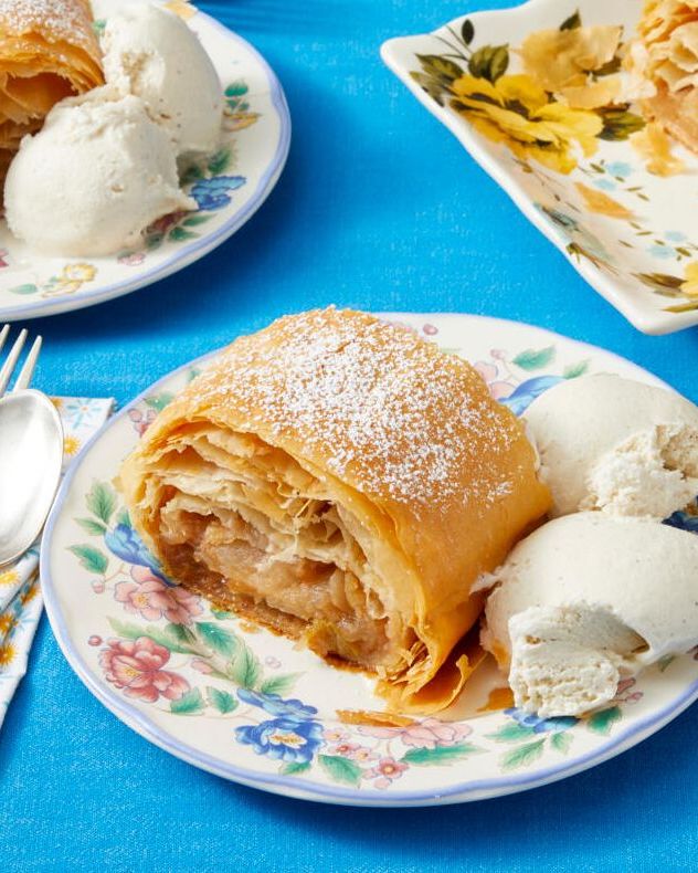 apple strudel slice on plate with ice cream blue background