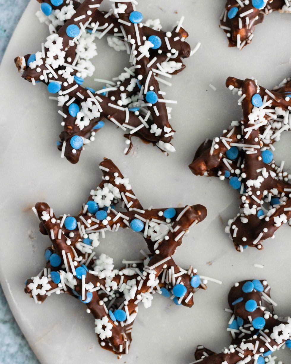 chocolate covered pretzel stars with white and blue sprinkles
