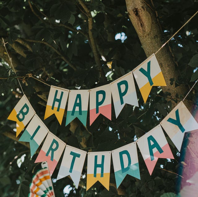 a 'happy birthday' banner hangs from a tree