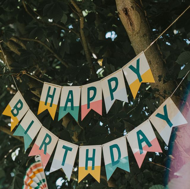 a 'happy birthday' banner hangs from a tree