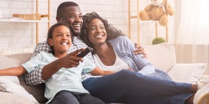 happy family relaxing and watching tv at home