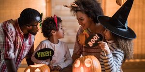happy black family talking while enjoying in halloween at home