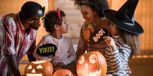 happy black family talking while enjoying in halloween at home