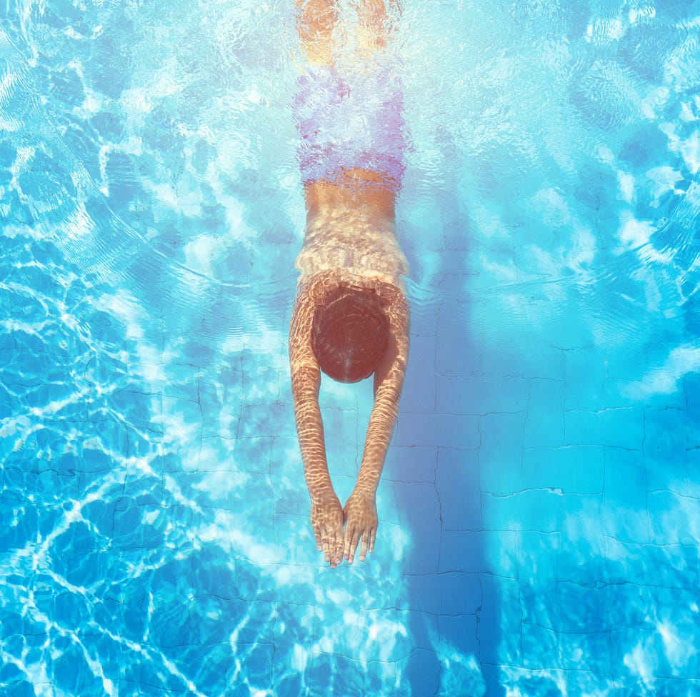Happy boy diving in the swimming pool Happy boy diving in the swimming pool