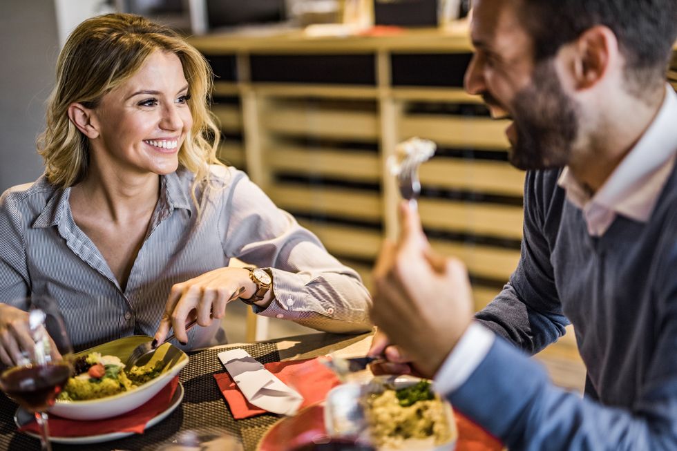 happy business couple talking on a lunch in restaurant