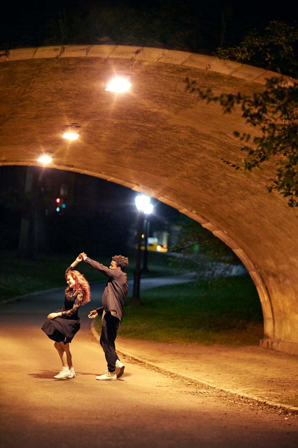 happy couple dancing on street at night