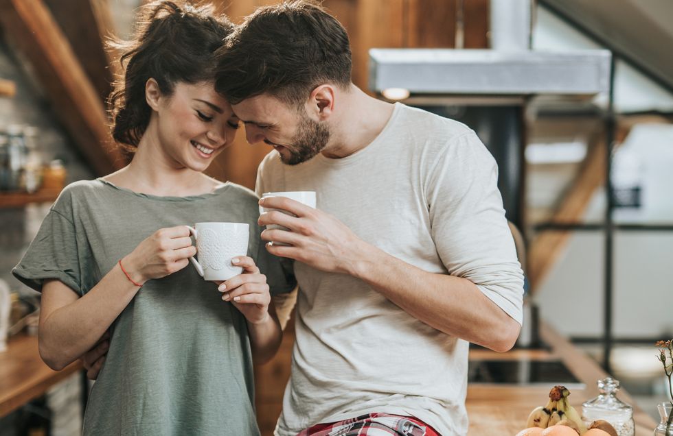 happy couple in love flirting during coffee time at home