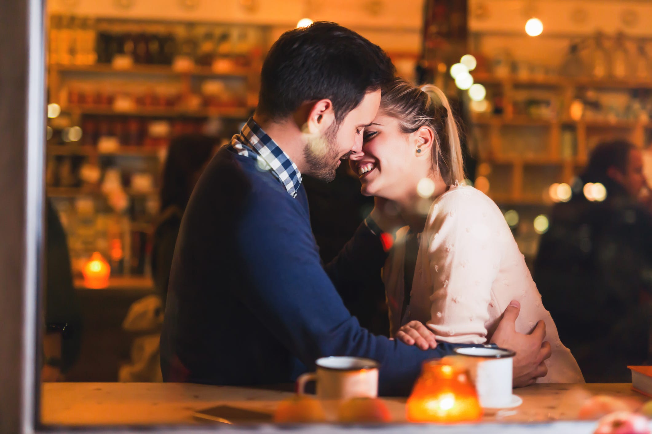 happy-couple-kissing-at-bar-and-having-d