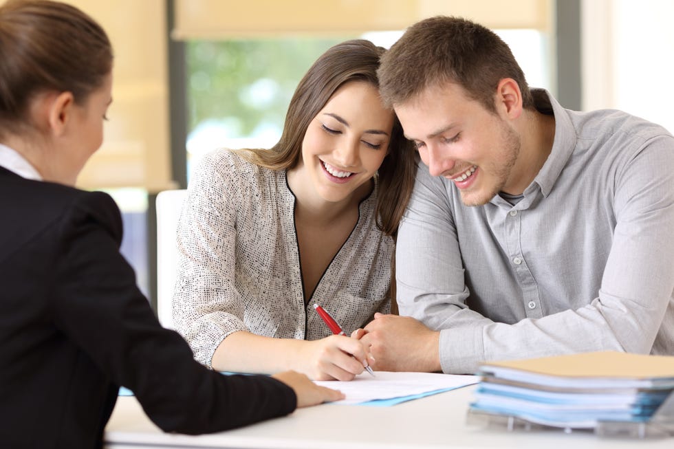 divorce expert tips - Happy couple signing a contract at office