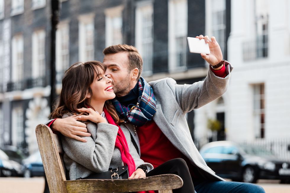 Happy couple taking selfie in the London city