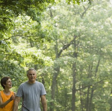 happy couple walking along road together
