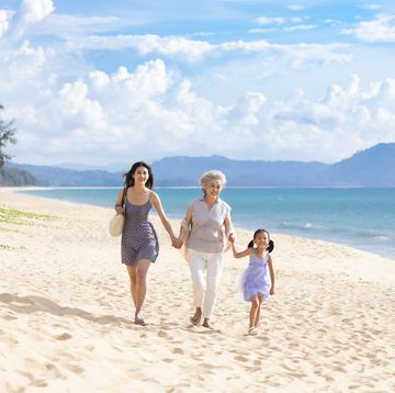 happy family walking on beach