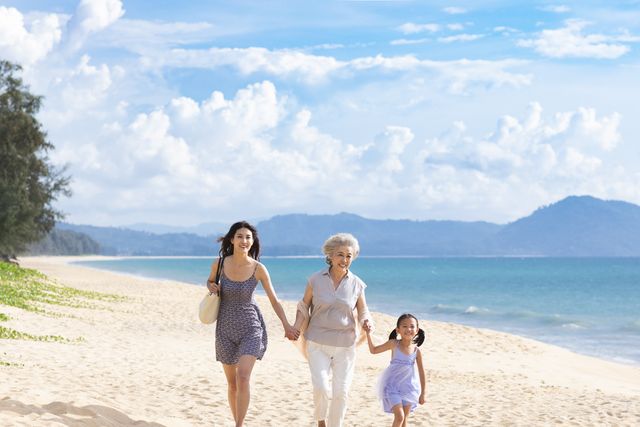 happy family walking on beach