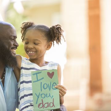 happy father's day girl gives card to dad