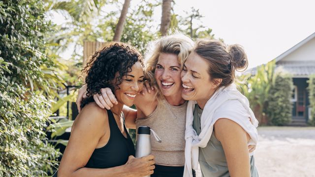 happy female friends embracing each other at wellness resort