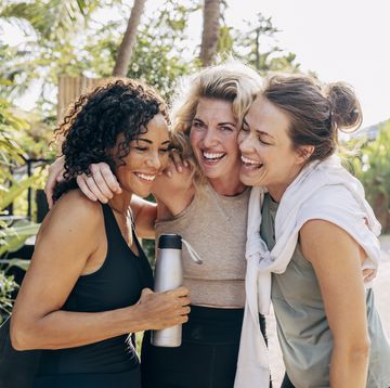 happy female friends embracing each other at wellness resort