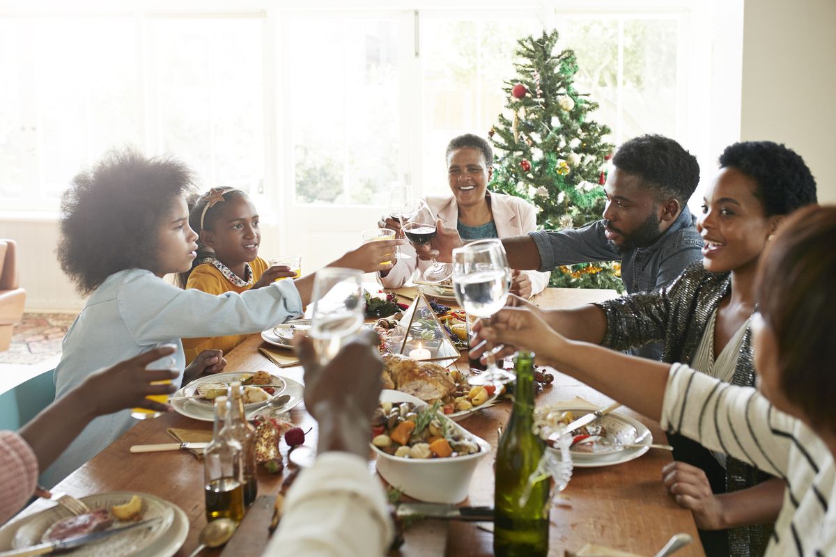 happy friends and family toasting drinks at home, how to set boundaries around diet culture talk